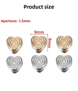 Detailed view of 9mm heart beads in gold and silver with concentric circle patterns
