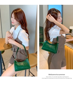 Detail of dark green crocodile texture on a retro PU leather underarm shoulder bag