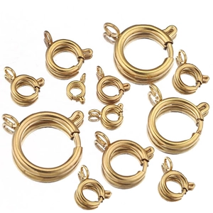 Detailed view of various sizes of golden stainless steel spring ring clasps for jewelry