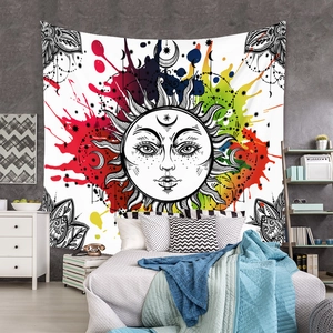 Detail of bohemian sun tapestry with colorful ink splashes on bedroom wall