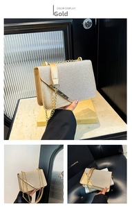 Detail of gold glitter crossbody bag with metal chain strap and shimmer finish texture