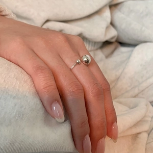 Detail of S925 sterling silver open ring with dual geometric beads on model's finger