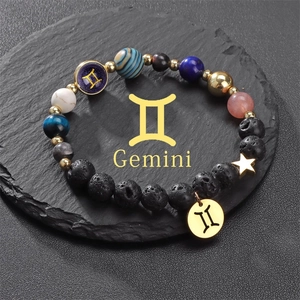 Solar system galaxy bracelet with natural stones and Gemini symbol on black stone plate