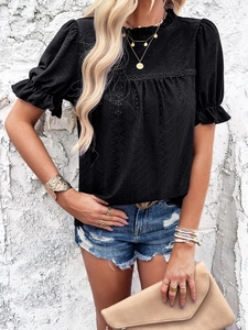 Close-up of black short sleeve top featuring hollow texture fabric and ruffled edges