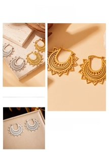 Detailed close-up of vintage hollow flower earrings in gold and silver finish