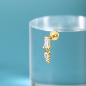 Macro detail of S925 sterling silver gold stud featuring rectangular and round crystals