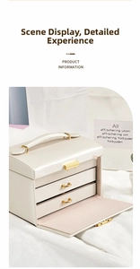 Detail of cream white PU leather jewelry box featuring gold handles and three-tier storage