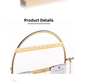 Detail of golden jewelry stand with multiple holes for hanging earrings and display cards