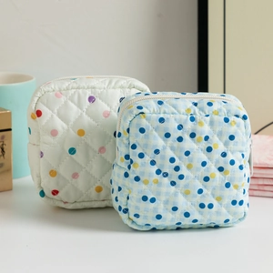 Close-up of quilted floral sanitary bag with high-quality zipper and thick cotton texture
