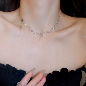 Elegant silver butterfly zircon tassel necklace with heart-wave chain worn on collarbone