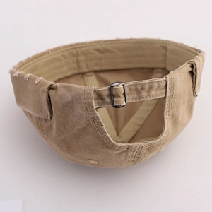 Detail of adjustable strap and vintage metal buckle on a khaki washed cotton docker hat
