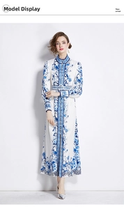 Detail of elegant blue floral print dress with high collar and buttoned waist belt