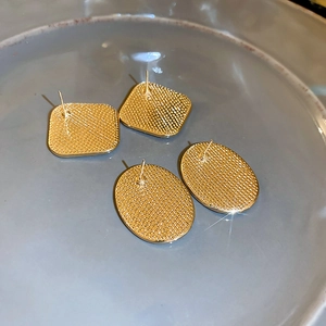 Detailed back view of gold geometric earrings showing textured finish and stud pins