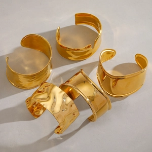 Minimalist wide open gold bangles with hammered and smooth irregular metal textures