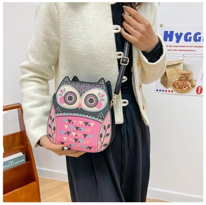 Detailed view of creative cartoon owl shaped crossbody bag with adjustable strap on a model