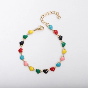 Detailed close-up of 18k gold plated bracelet featuring colorful enamel heart charms
