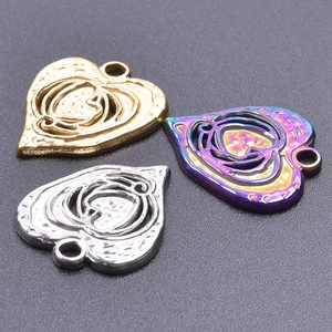 Macro view of hollow heart pendants in gold, silver, and rainbow plated finishes