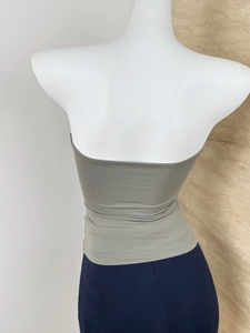 Detailed back view of a grey-green elastic knit tube top on a fashion mannequin