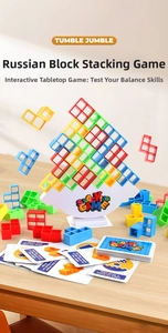 Colorful tetris balance blocks with white base and game cards on wooden background