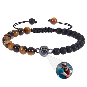 Macro view of projection stone bead showing custom portrait photo on woven bracelet