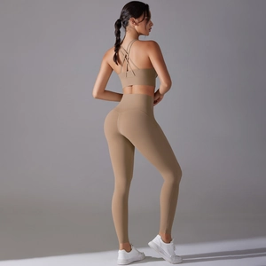 Detail of coffee brown yoga set featuring cross-back sports bra and high-waist leggings