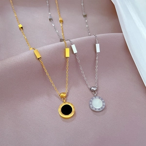 Minimalist titanium steel Roman numeral necklaces in gold and silver on soft fabric