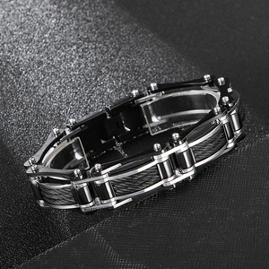 Detailed macro shot of industrial stainless steel cable links on a black textured surface