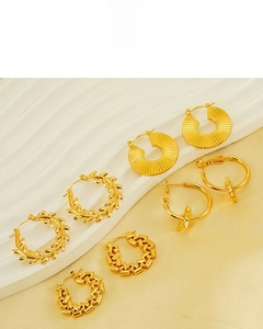 Detailed macro view of 18K gold plated hoop earrings with textured star and twist designs