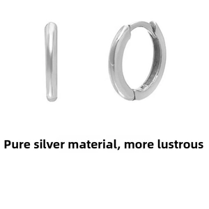 Macro shot of polished sterling silver hoop earrings showcasing smooth texture and luster