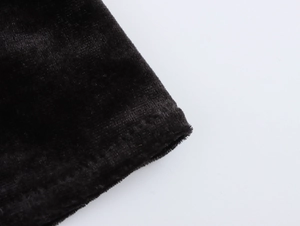 Close-up of premium black velvet fabric texture showing soft luster and fine weave