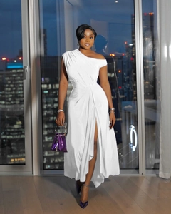 Detail of elegant white one-shoulder maxi dress with pleated texture and high side slit