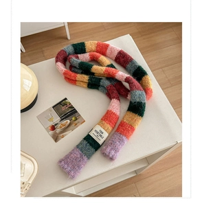 Close-up of vibrant rainbow striped knit scarf texture and warm wool craftsmanship
