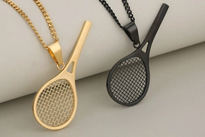 Detailed shot of creative tennis racket pendants in gold and black with Cuban chains