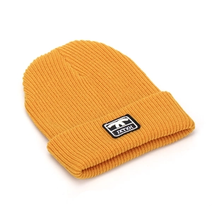 Detailed close-up of a ribbed knit beanie in bright yellow with a black embroidery tag