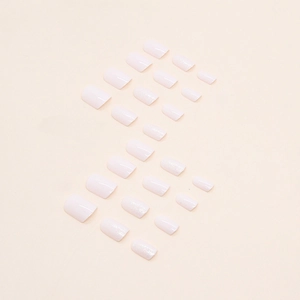 Pink aurora glitter press-on nails in short square-round shape set on a beige background