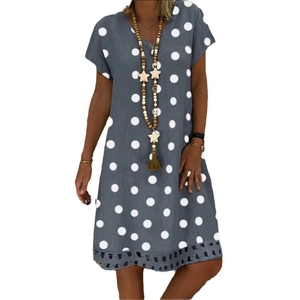 Detail of V-neckline and hollow lace trim on polka dot printed summer dress