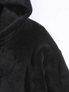 Detailed close-up of the plush black coral fleece texture and hooded neckline of the hoodie