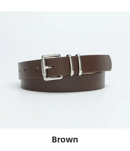 Close-up of minimalist brown leather belt with silver buckle and polished metal loops