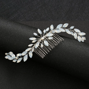 Macro detail of silver wedding hair comb with marquise opal gemstones and wire weave