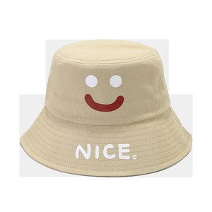 Close-up of beige cotton bucket hat with smile face and NICE embroidery on the wide brim