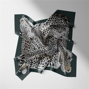 Detail of silk square scarf featuring dark green leopard print with soft folds