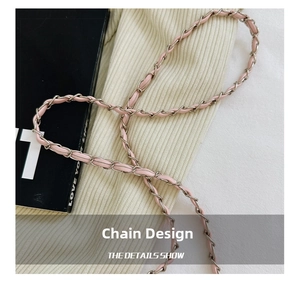 Close-up of pink leather woven with silver metal chain strap on a quilted handbag