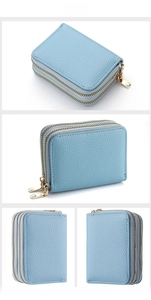 Detailed view of the blue pebble grain leather card holder with double gold zippers