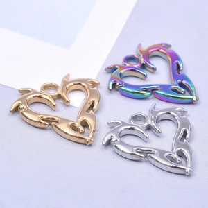 Detailed view of heart pendants in gold, silver, and rainbow finishes with dragon patterns