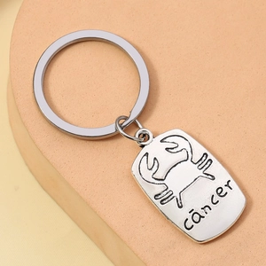 Silver Cancer zodiac metal keychain with crab symbol and letter engraving on rectangle tag