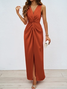 Detail of elegant V-neck dress with waist twist knot and high slit in rust red