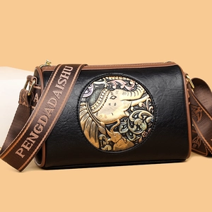Vintage black cylinder shoulder bag with golden embossed elephant and wide brown strap
