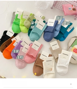 Flat lay of colorful combed cotton socks in twenty vibrant shades for daily style