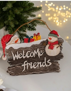Detail of wooden Christmas welcome sign with 3D snowmen and Welcome Friends text