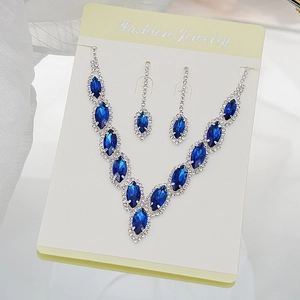 Detailed macro view of crystal necklace and earrings set with blue marquise gems